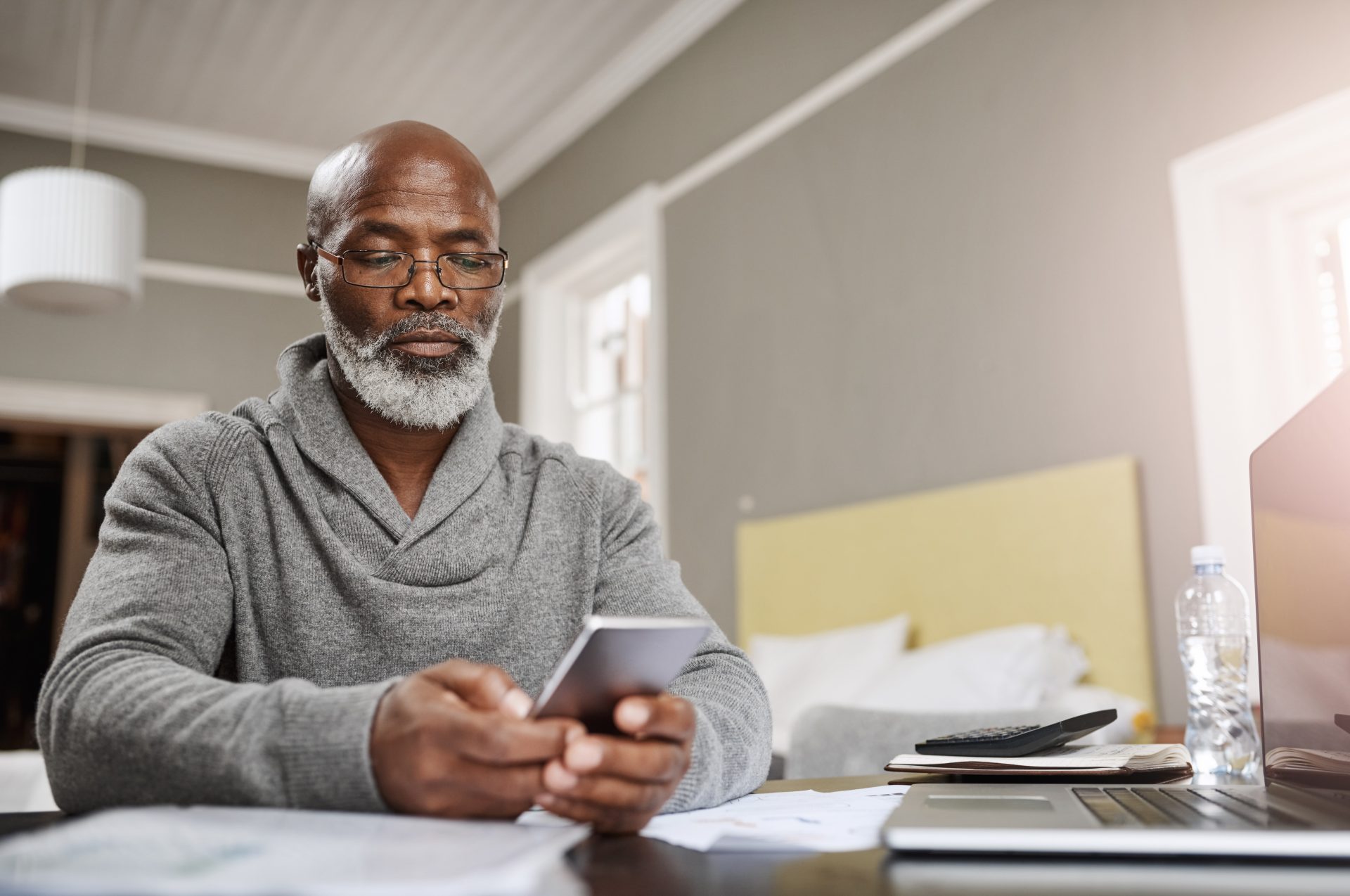 Man using a mobile phone in his home.