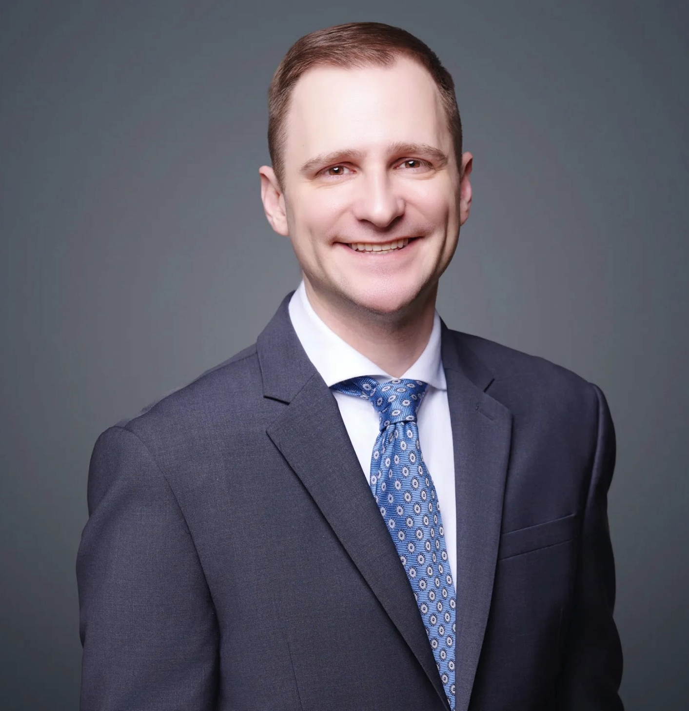 smiling white male in 3 piece suit
