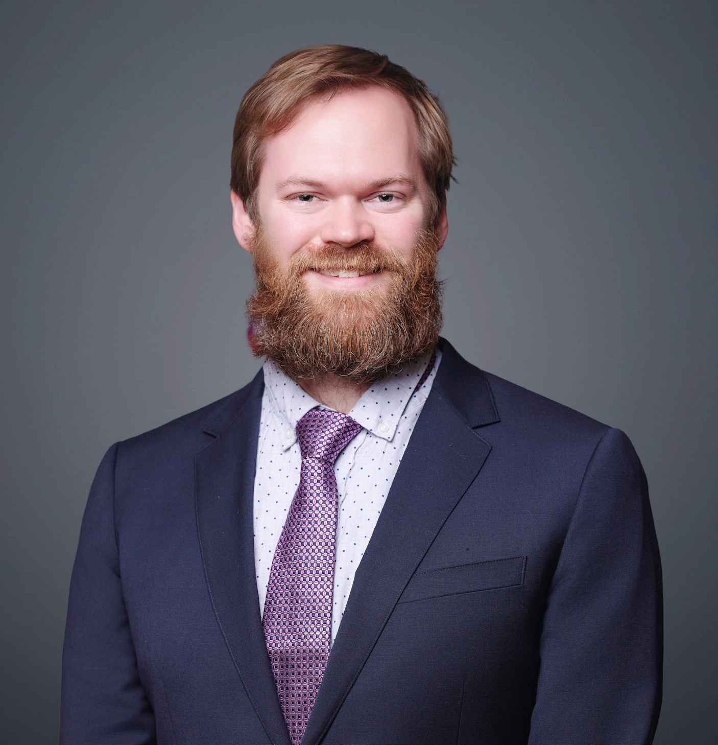 white male with facial hair in 3 piece suite